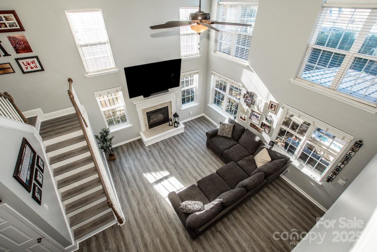 182 Harris Farm Road Mooresville, NC 28115 - Photo 25 of 44 a living room with furniture a flat screen tv and a fireplace