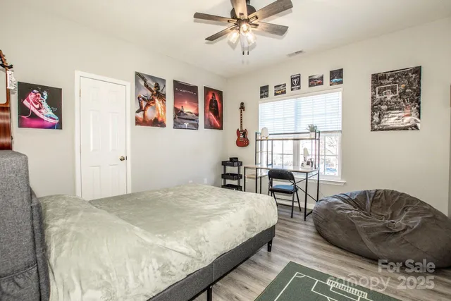 a spacious bedroom with a bed a couch and a window