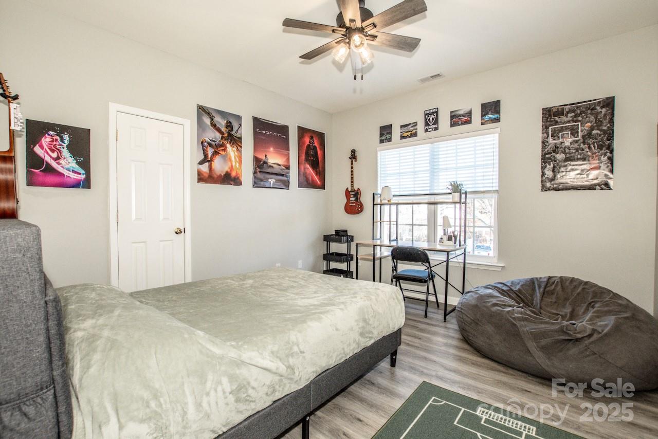 182 Harris Farm Road Mooresville, NC 28115 - Photo 26 of 44 a spacious bedroom with a bed a couch and a window