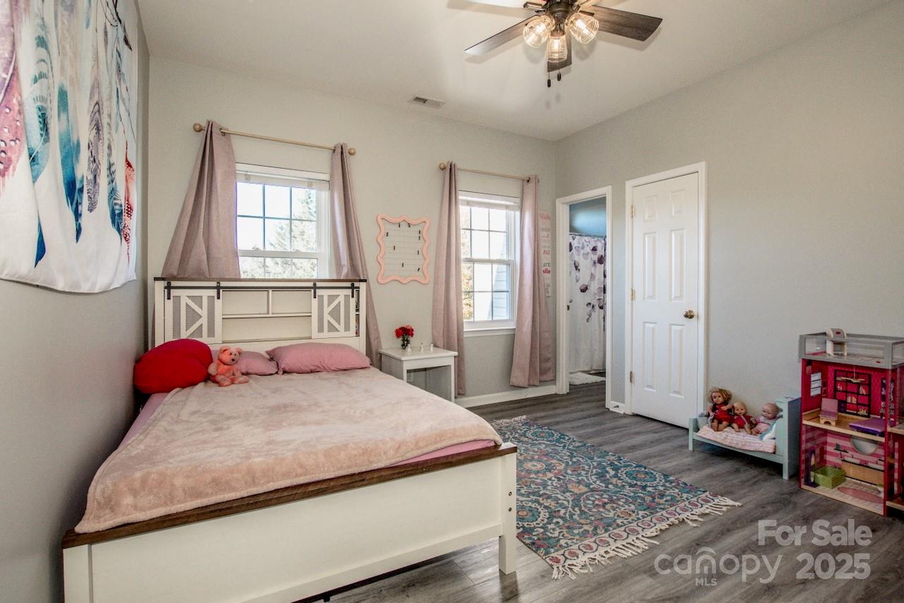 182 Harris Farm Road Mooresville, NC 28115 - Photo 29 of 44 a bedroom with a bed and a chandelier
