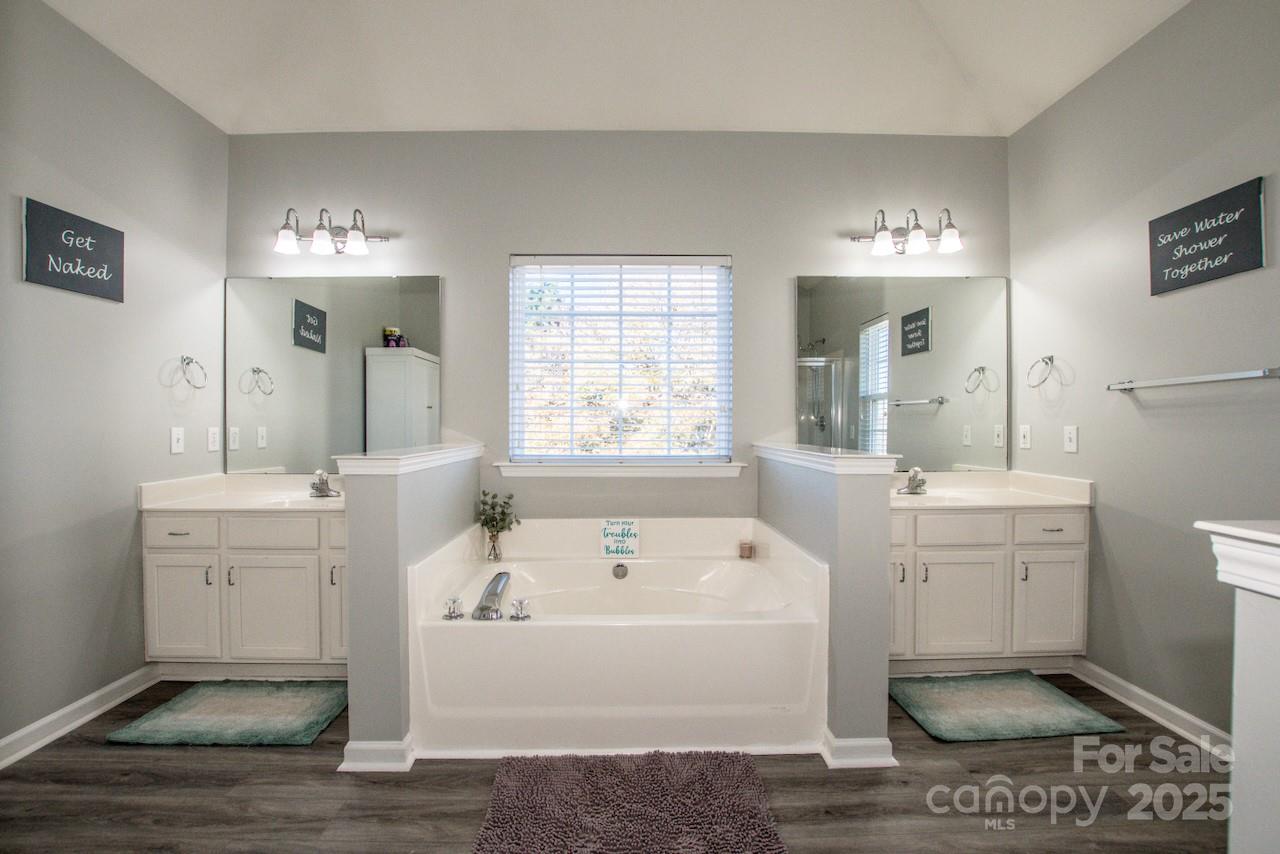 182 Harris Farm Road Mooresville, NC 28115 - Photo 35 of 44 a bathroom with a bathtub a sink and a window