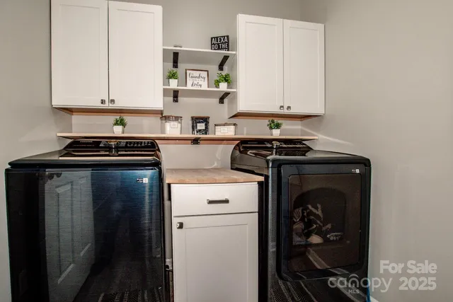 a living room with furniture floor to ceiling window and a flat screen tv