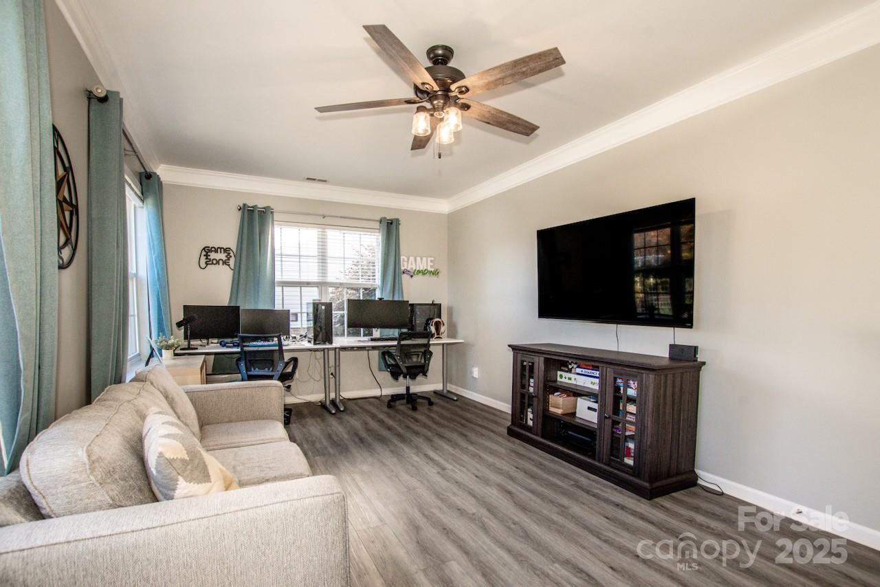 182 Harris Farm Road Mooresville, NC 28115 - Photo 40 of 44 a living room with furniture and a flat screen tv