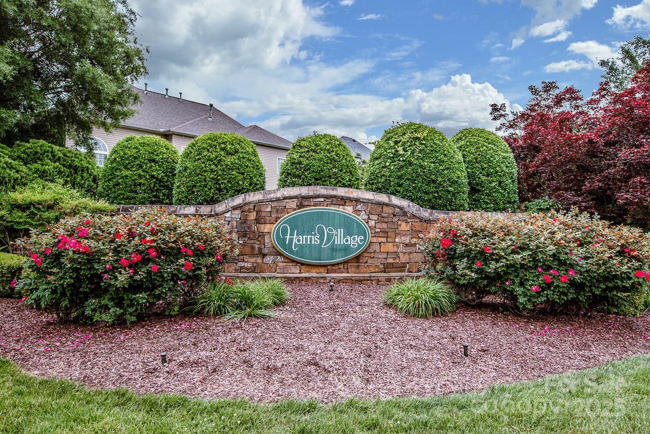 182 Harris Farm Road Mooresville, NC 28115 - Photo 44 of 44 a view of a garden with a lot of flower plants and wooden fence
