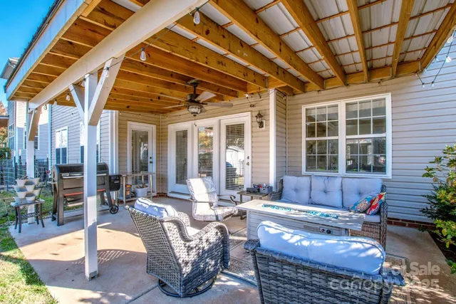 a building outdoor space with patio furniture and potted plants