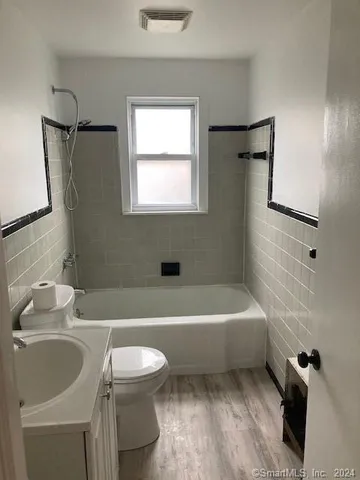 a bathroom with a sink a toilet and a bathtub