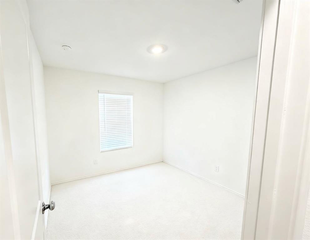 7855 Rutherford Lane McKinney, TX 75071 - Photo 4 of 27 Recessed ceiling lighting, window with horizontal blinds, neutral wall paint, and light-colored carpeting
