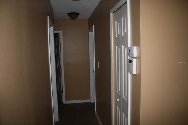 a view of an empty room with closet area