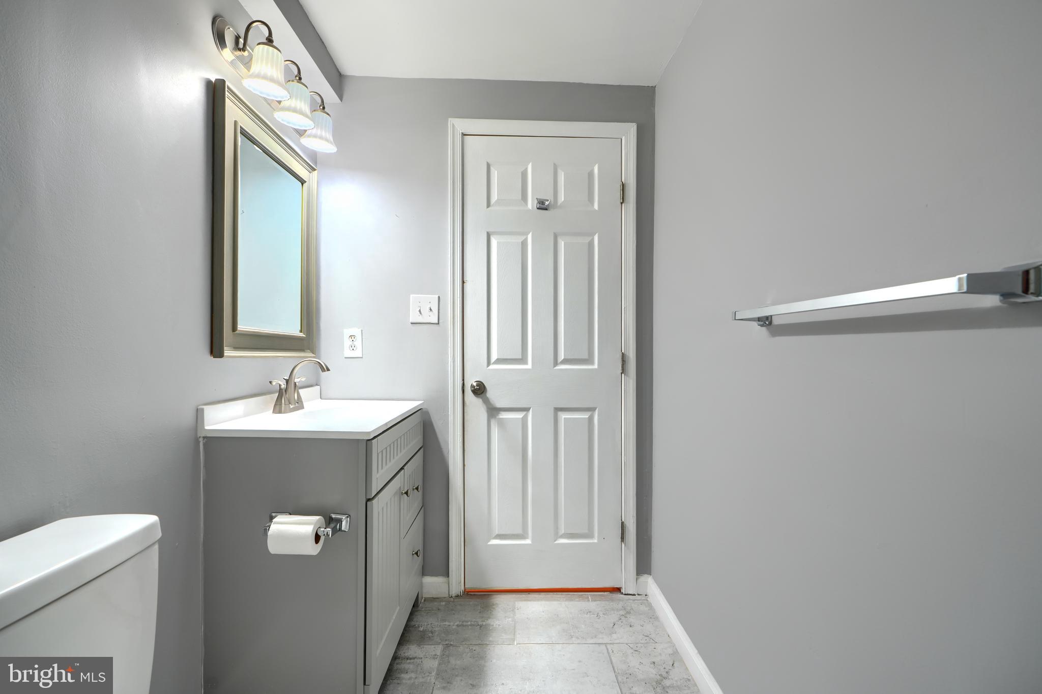 1713 Sea Pine Circle Severn, MD 21144 - Photo 30 of 33 a bathroom with a sink a toilet and mirror