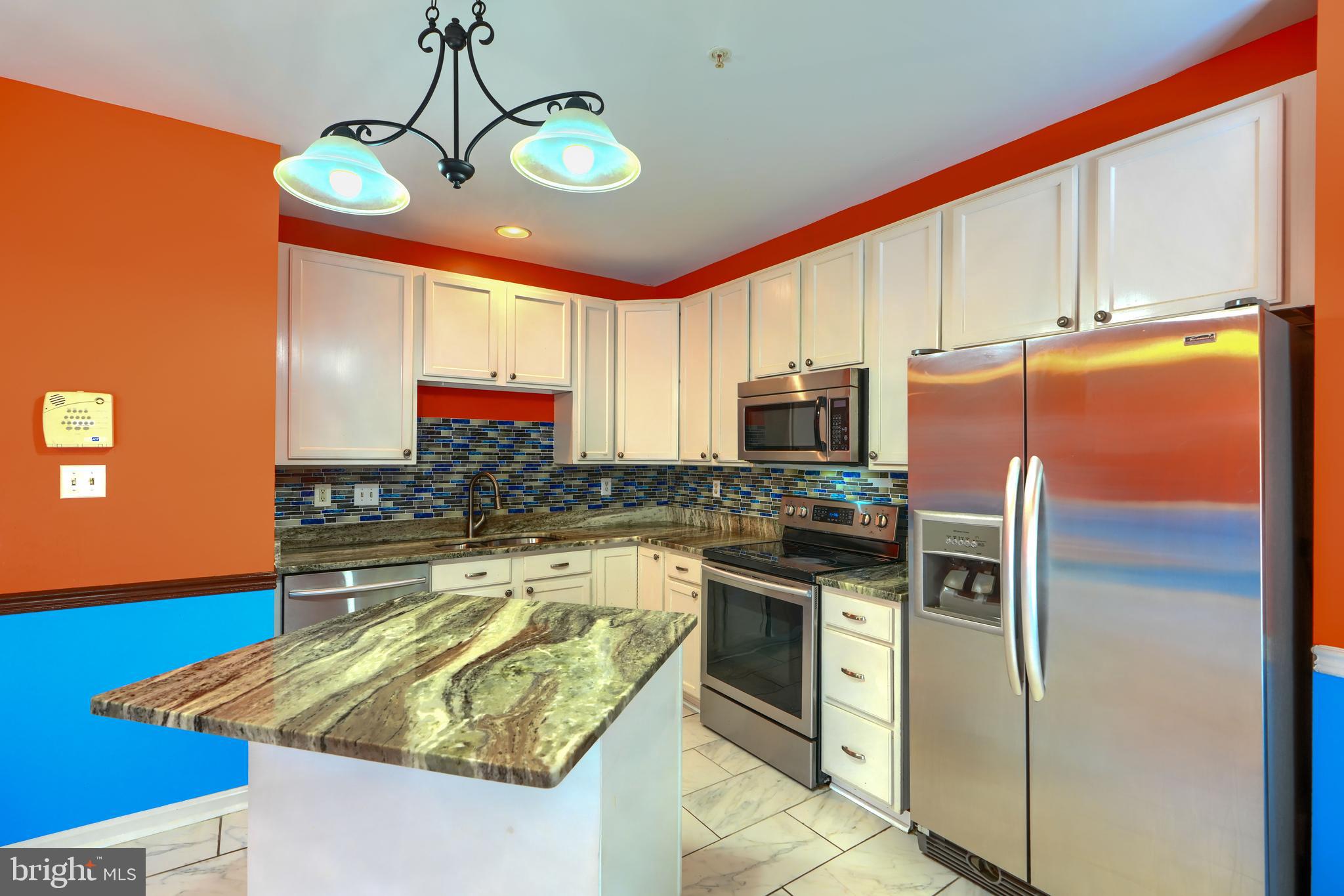 1713 Sea Pine Circle Severn, MD 21144 - Photo 9 of 33 a kitchen with stainless steel appliances granite countertop a sink a stove and refrigerator