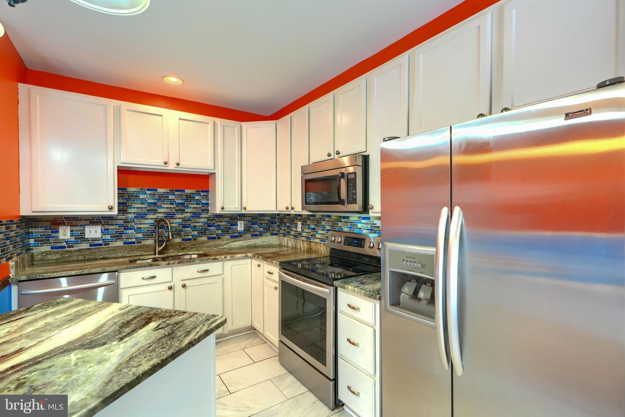 1713 Sea Pine Circle Severn, MD 21144 - Photo 10 of 33 a kitchen with stainless steel appliances granite countertop a stove a sink and a microwave