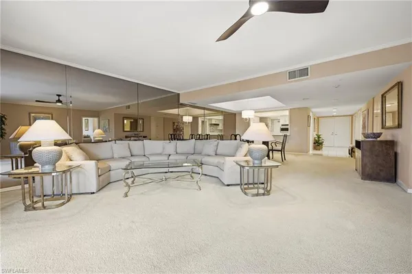a living room with furniture and a chandelier