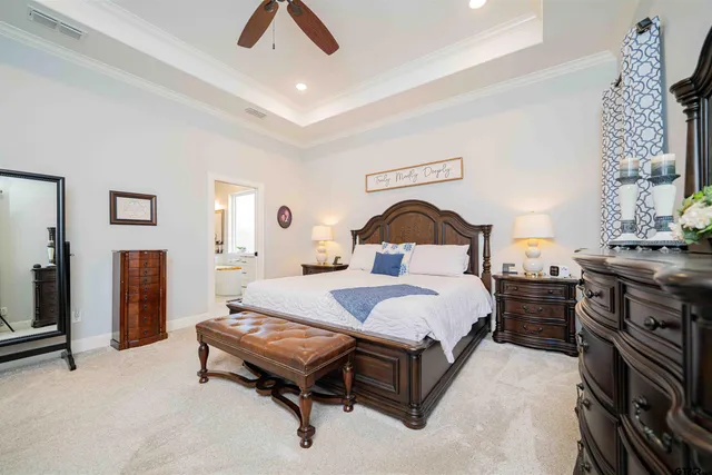 a bedroom with a bed and dresser with mirror