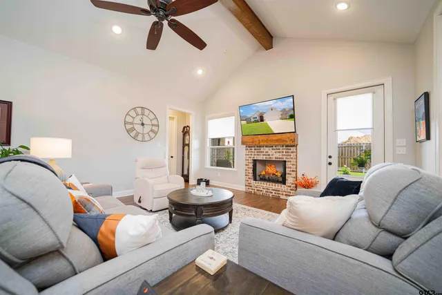 a living room with a couch and a dining table with wooden floor