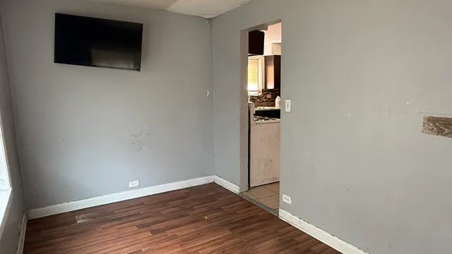 a view of a house with wooden deck front of house