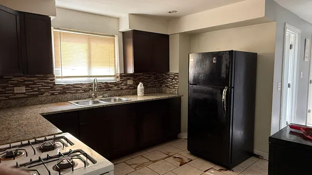 a kitchen with a sink stove and refrigerator