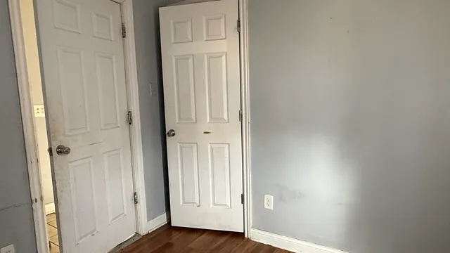 an empty room with wooden floor