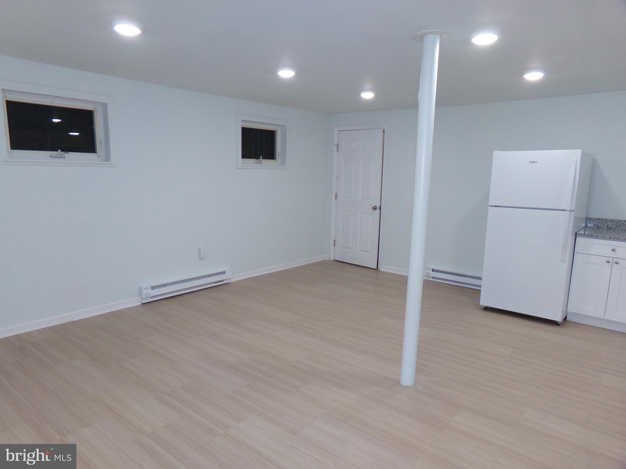 276 East Main Street, Unit 5 Westminster, MD 21157 - Photo 22 of 23 an empty room with wooden floor and windows