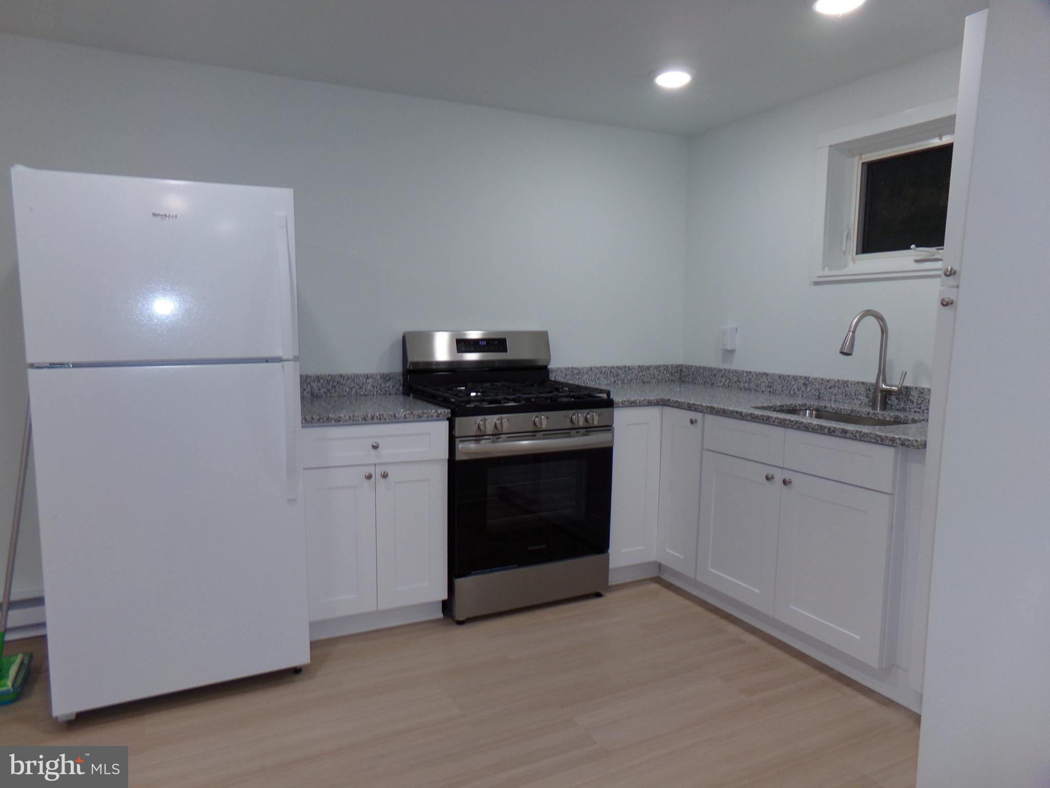 276 East Main Street, Unit 5 Westminster, MD 21157 - Photo 5 of 23 a kitchen with a sink stove and microwave
