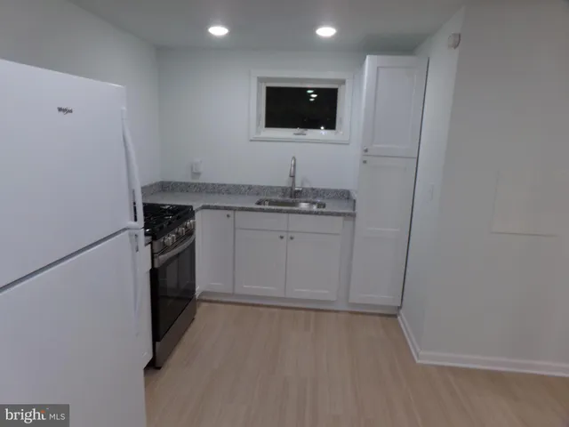 a kitchen with a sink and a stove top oven