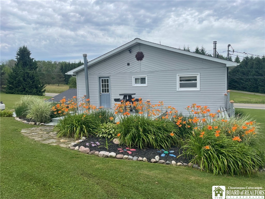 3833 Sherman Ripley Road Sherman, NY 14781 - Photo 45 of 48 Back of home in summer. the deck is behind the ga