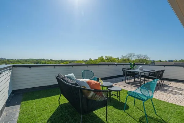 a view of a chairs and table in patio
