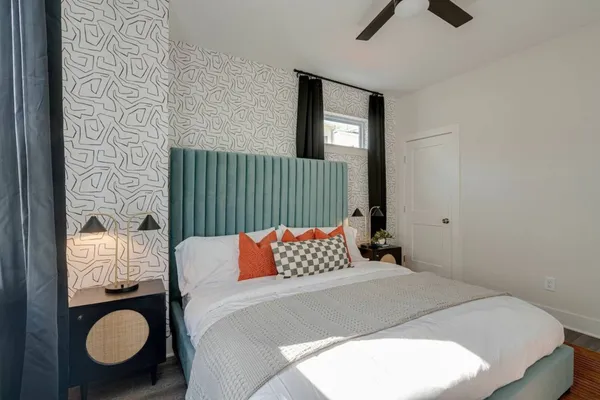 a bedroom with bed and wooden floor