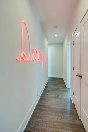 a view of a room with wooden floor and white wall