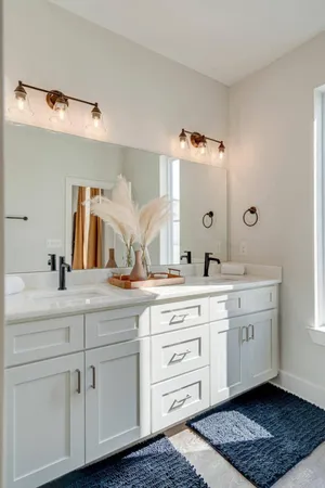a spacious bathroom with a granite countertop sink and a mirror