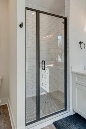 a bathroom with a glass shower door