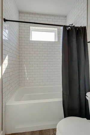 a bathroom with a shower toilet and sink