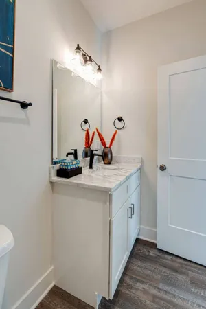 a bathroom with a sink and mirror with toilet