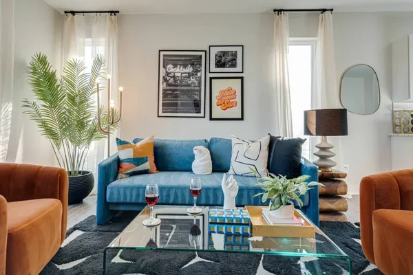 a living room with furniture fireplace and a large window