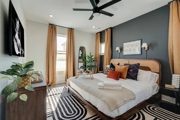 a bedroom with a bed and a chandelier