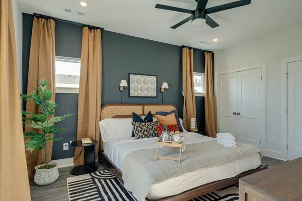 a bed sitting in a bedroom next to a window