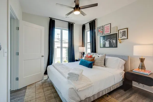 a bedroom with a bed and a chandelier