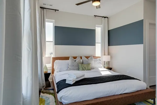 a bedroom with a bed lamp and a fireplace