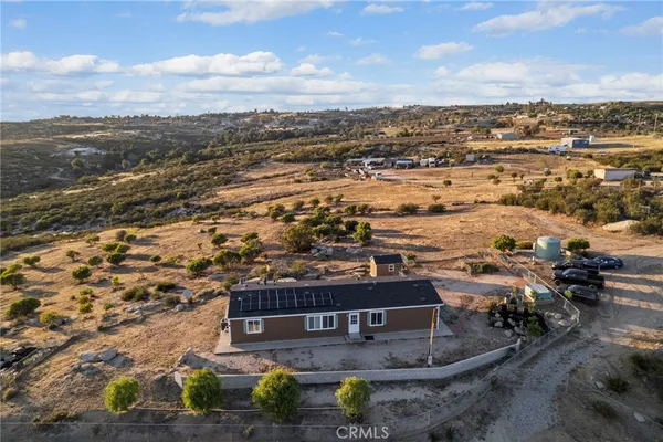 an aerial view of residential houses with outdoor space and ocean