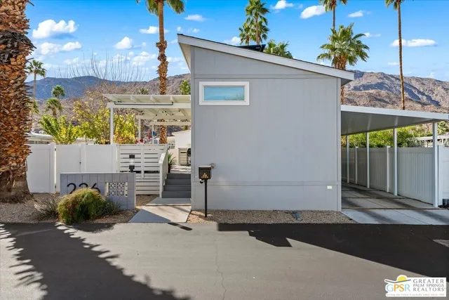 a view of a chairs and table in backyard