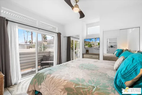 a bedroom with a bed and a large window