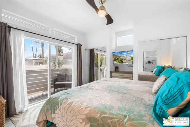 a bedroom with a bed and a large window