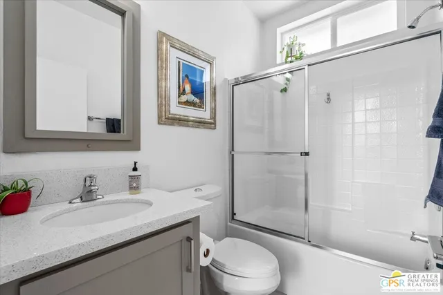 a view of an empty room with window and bathroom