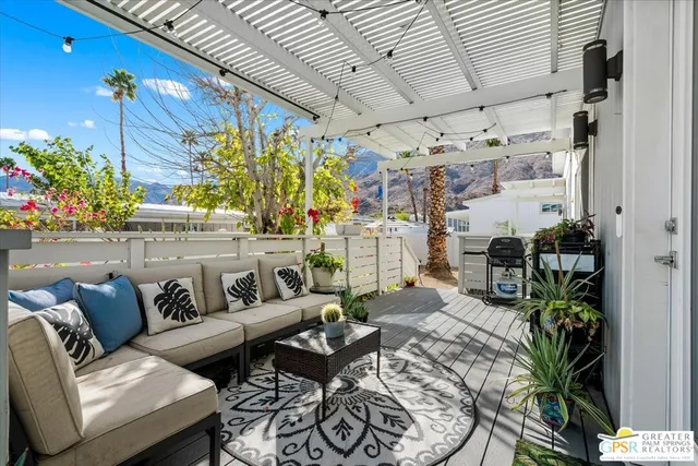 a living room with furniture a rug and a wall painting