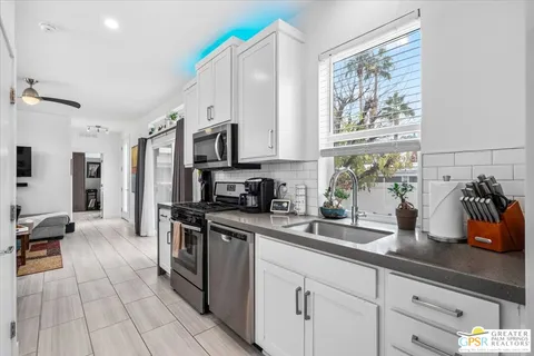 a bedroom with a bed and painting on the wall