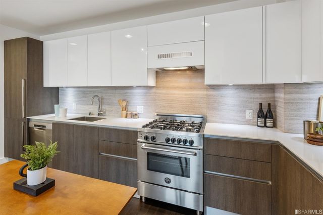 a kitchen with a stove cabinets and window