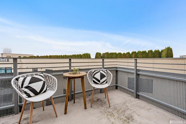 a view of a chair and table in the balcony