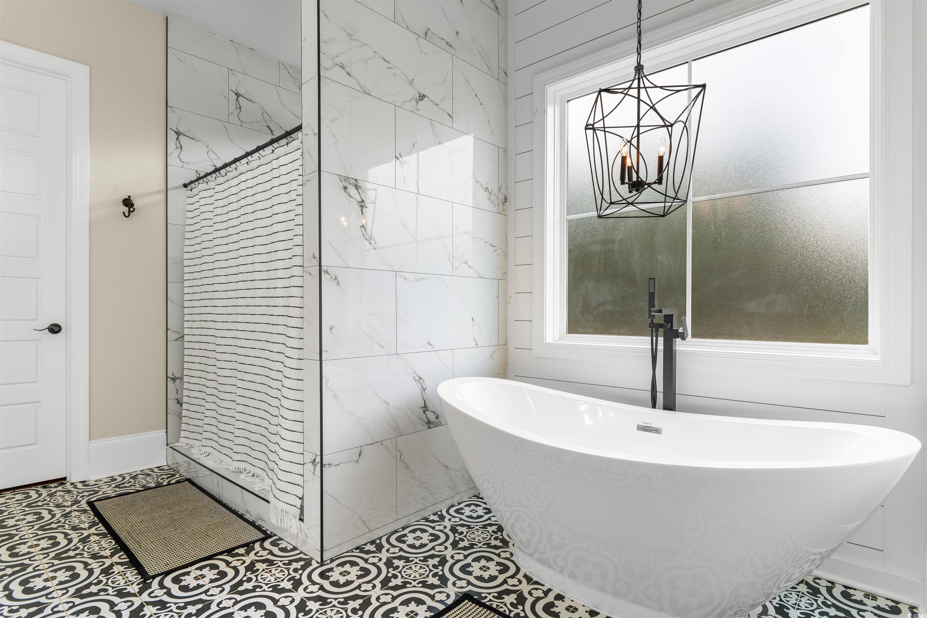 4785 Valley Forge Road Aynor, SC 29511 - Photo 15 of 40 Bathroom featuring a chandelier, a tub to relax in