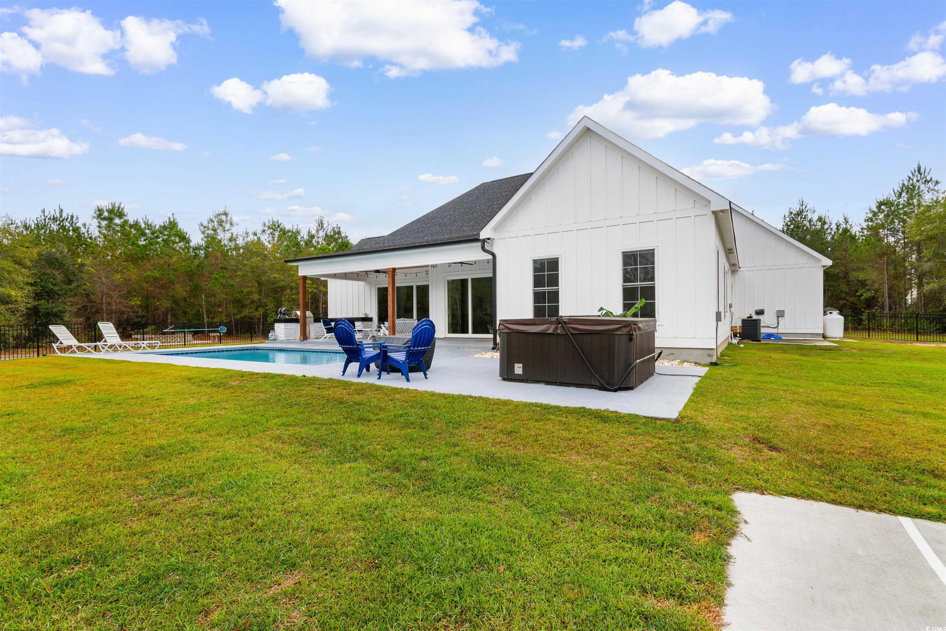 4785 Valley Forge Road Aynor, SC 29511 - Photo 2 of 40 Back of house with a pool with hot tub, a yard, an