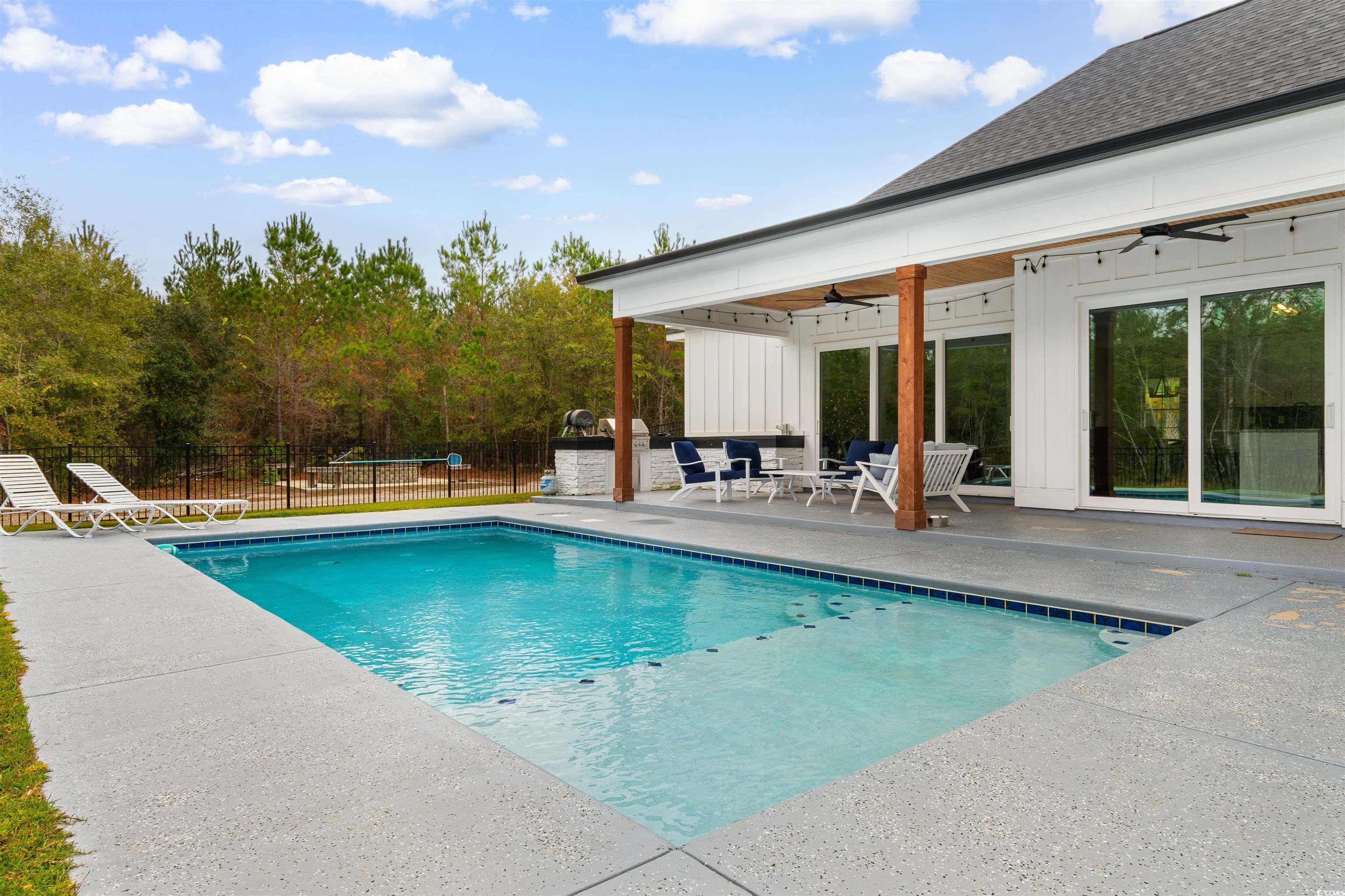 4785 Valley Forge Road Aynor, SC 29511 - Photo 23 of 40 View of swimming pool with ceiling fan and a patio