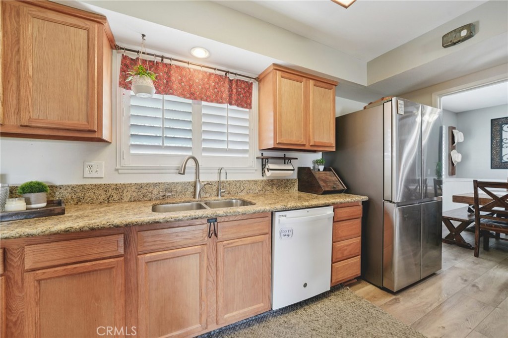 2821 Riding Ring Road Norco, CA 92860 - Photo 14 of 54 a kitchen with stainless steel appliances granite countertop a sink a refrigerator and cabinets